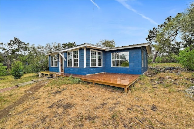 18502 E Lakeview Dr, Jonestown, TX 78645 - view of side of home with a wooden deck and concrete block siding