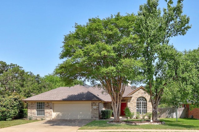 single story home with an attached garage, concrete driveway, fence, and a front lawn