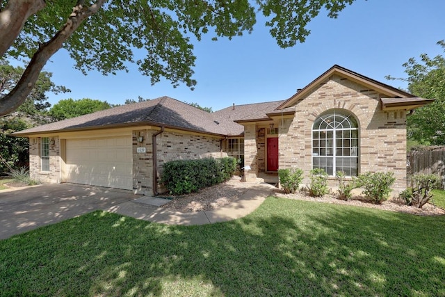 ranch-style house featuring a front yard, a garage, concrete driveway, brick siding, and roof with shingles