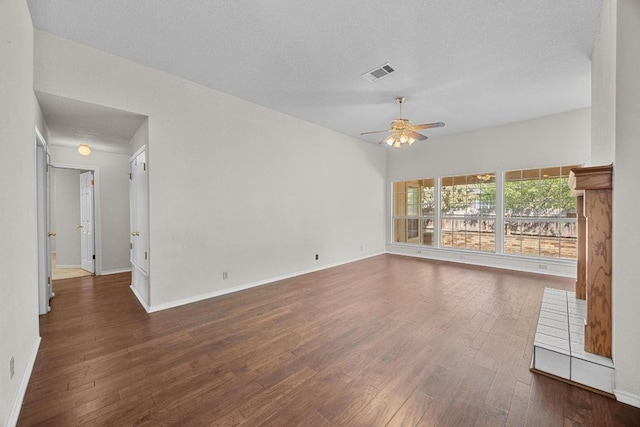 unfurnished living room featuring visible vents, baseboards, wood finished floors, and ceiling fan