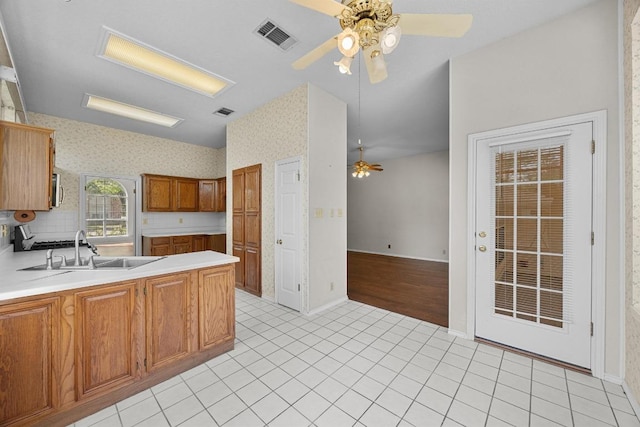 kitchen with light countertops, visible vents, a sink, and a ceiling fan