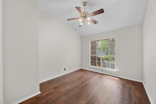 unfurnished room with baseboards, ceiling fan, hardwood / wood-style flooring, and vaulted ceiling