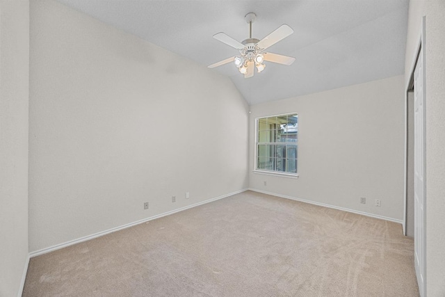 unfurnished bedroom featuring baseboards, a ceiling fan, vaulted ceiling, and carpet floors