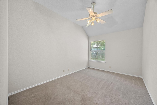 unfurnished room featuring baseboards, carpet flooring, and vaulted ceiling
