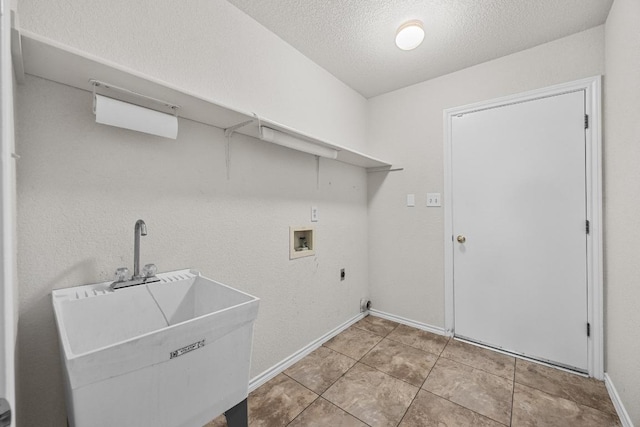 washroom with baseboards, a sink, laundry area, hookup for an electric dryer, and hookup for a washing machine