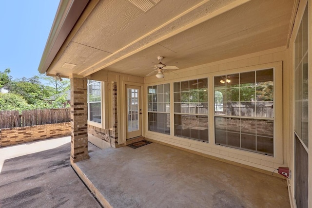 view of patio / terrace with fence and a ceiling fan