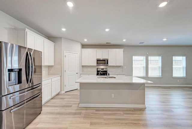 1528 Longhorn Ranch Dr, Leander, TX 78641 - kitchen with appliances with stainless steel finishes, light countertops, tasteful backsplash, and recessed lighting