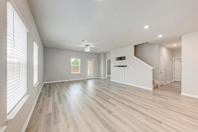 1528 Longhorn Ranch Dr, Leander, TX 78641 - unfurnished living room with stairway, light wood-style floors, ceiling fan, and recessed lighting