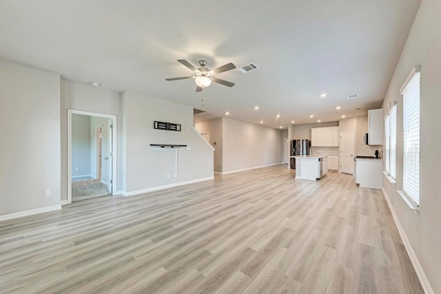 1528 Longhorn Ranch Dr, Leander, TX 78641 - unfurnished living room with a ceiling fan, light wood-style floors, recessed lighting, and stairs