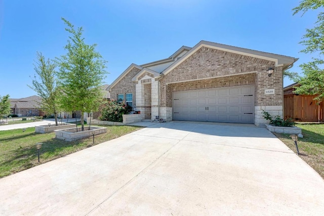1528 Longhorn Ranch Dr, Leander, TX 78641 - view of front facade featuring concrete driveway, an attached garage, stone siding, and brick siding