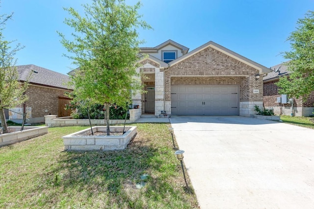 1528 Longhorn Ranch Dr, Leander, TX 78641 - view of front of home featuring an attached garage, driveway, brick siding, and a front yard