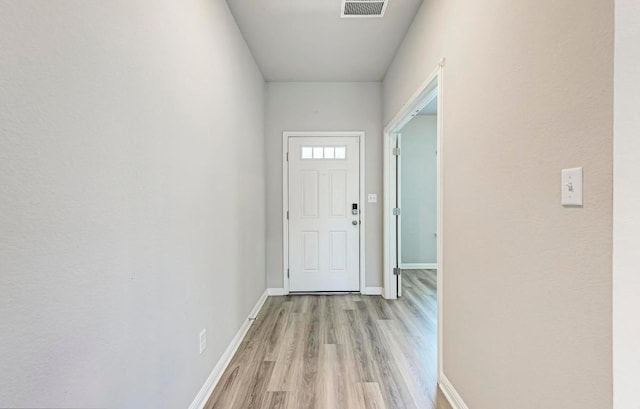 1528 Longhorn Ranch Dr, Leander, TX 78641 - doorway with light wood-style flooring and baseboards