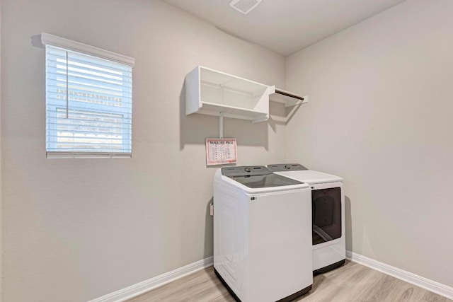 1528 Longhorn Ranch Dr, Leander, TX 78641 - laundry area with washing machine and dryer and light wood-type flooring