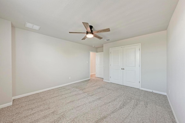1528 Longhorn Ranch Dr, Leander, TX 78641 - unfurnished bedroom featuring carpet, a closet, and a ceiling fan