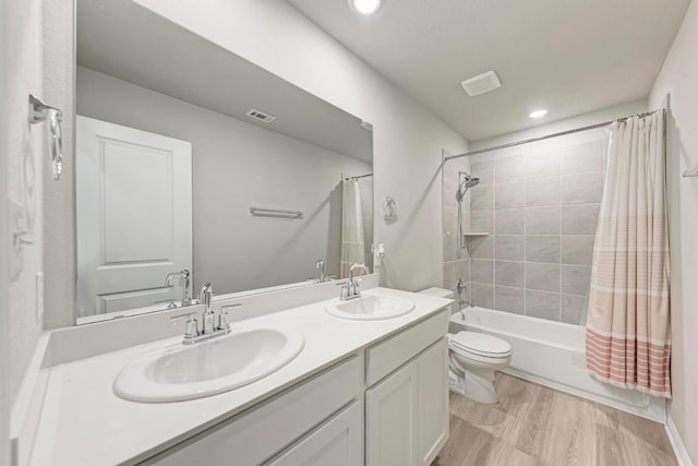 1528 Longhorn Ranch Dr, Leander, TX 78641 - full bath with double vanity, shower / tub combo with curtain, wood finished floors, and recessed lighting