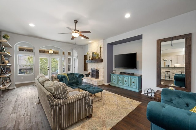 109 Lombardia Dr, Lakeway, TX 78734 - living area with arched walkways, ceiling fan, recessed lighting, wood finished floors, and french doors