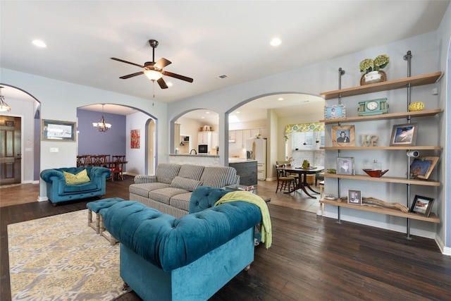 109 Lombardia Dr, Lakeway, TX 78734 - living area with arched walkways, a ceiling fan, a chandelier, wood finished floors, and recessed lighting