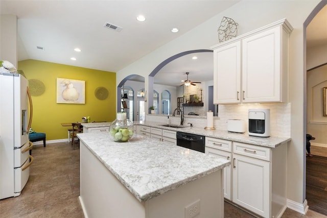 109 Lombardia Dr, Lakeway, TX 78734 - kitchen featuring arched walkways, white fridge with ice dispenser, black dishwasher, ceiling fan, and recessed lighting