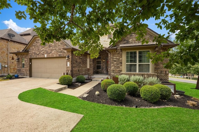 109 Lombardia Dr, Lakeway, TX 78734 - view of front of property featuring an attached garage, a front yard, concrete driveway, and brick siding