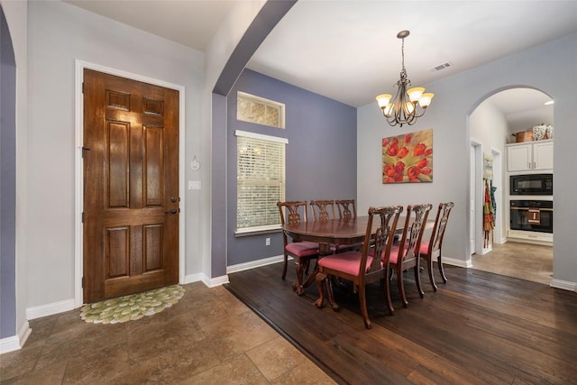 109 Lombardia Dr, Lakeway, TX 78734 - dining room featuring arched walkways and a chandelier