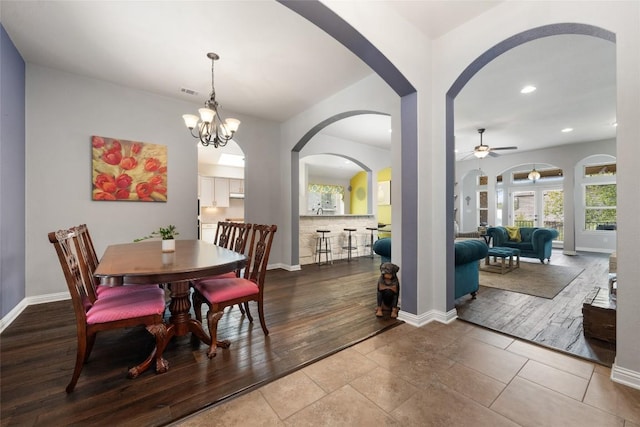 109 Lombardia Dr, Lakeway, TX 78734 - dining area featuring arched walkways, a ceiling fan, recessed lighting, wood finished floors, and a chandelier