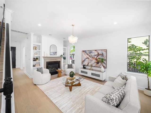 living room with baseboards, recessed lighting, light wood finished floors, stairs, and a premium fireplace