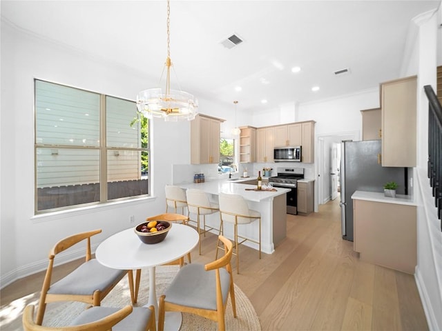 dining area with light wood-type flooring, an inviting chandelier, visible vents, and stairway