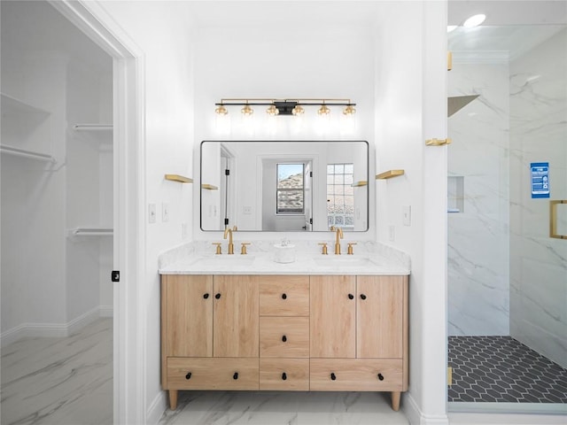 bathroom featuring a sink, baseboards, a marble finish shower, and marble finish floor