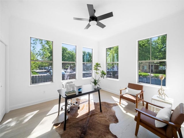 office with light wood-style floors, baseboards, and a ceiling fan