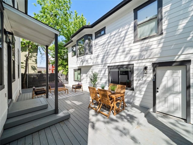 wooden terrace featuring outdoor dining space