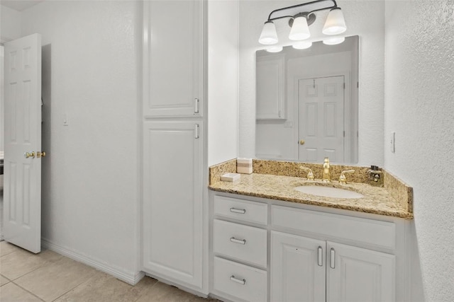 bathroom featuring tile patterned flooring and vanity