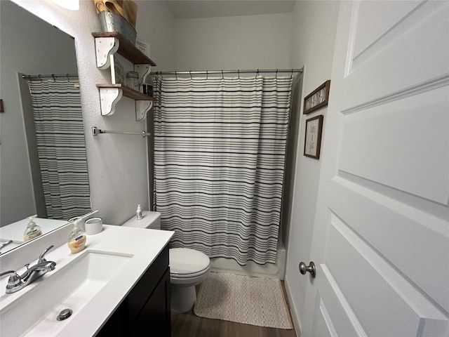 145 Cyrus Milton Dr, Buda, TX 78610 - bathroom with vanity, wood finished floors, and shower / bath combo