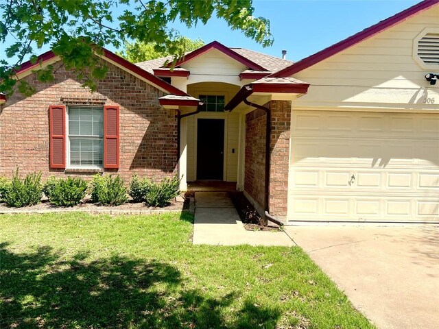 506 Clearcreek Dr, Leander, TX 78641 - view of front of property featuring a garage, a front yard, driveway, a shingled roof, and brick siding