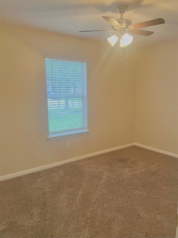 506 Clearcreek Dr, Leander, TX 78641 - spare room featuring carpet flooring, a ceiling fan, and baseboards