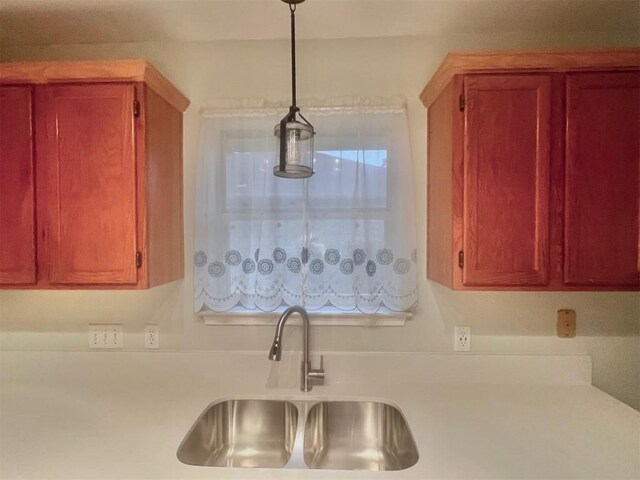 506 Clearcreek Dr, Leander, TX 78641 - kitchen featuring a sink, light countertops, and hanging light fixtures