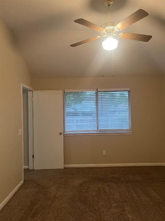 506 Clearcreek Dr, Leander, TX 78641 - empty room with carpet floors, vaulted ceiling, ceiling fan, and baseboards