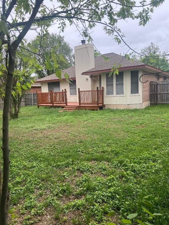 506 Clearcreek Dr, Leander, TX 78641 - rear view of house featuring a deck, roof with shingles, and a chimney