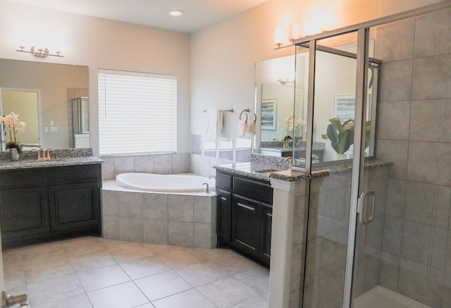 8801 Mina Dr, Austin, TX 78747 - bathroom featuring a garden tub, vanity, tile patterned floors, and a shower stall