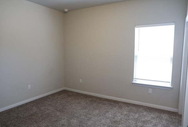 8801 Mina Dr, Austin, TX 78747 - empty room with dark carpet and baseboards