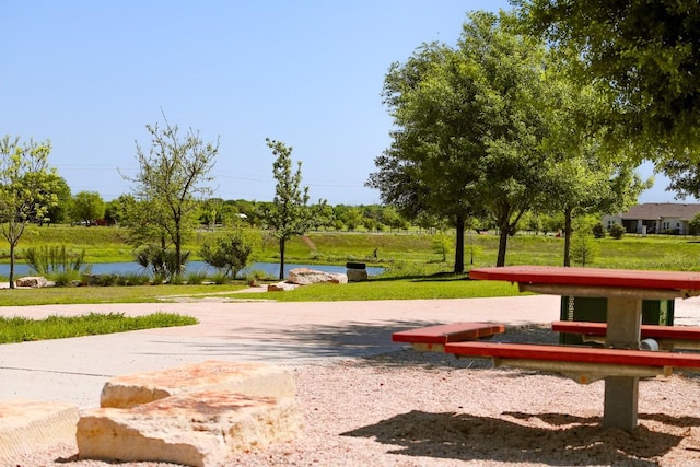 8801 Mina Dr, Austin, TX 78747 - view of home's community featuring a water view and a yard