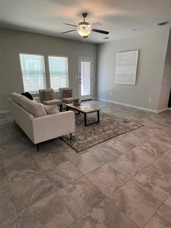 8801 Mina Dr, Austin, TX 78747 - tiled living area with ceiling fan and baseboards