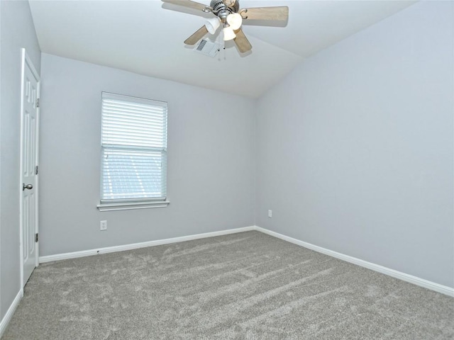 spare room featuring a ceiling fan, baseboards, carpet flooring, visible vents, and vaulted ceiling