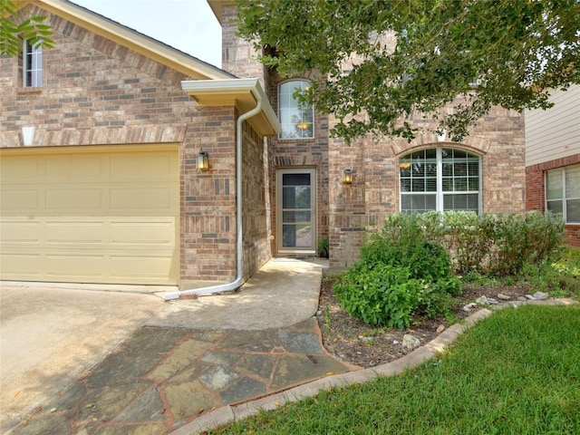 view of front of home with brick siding and an attached garage