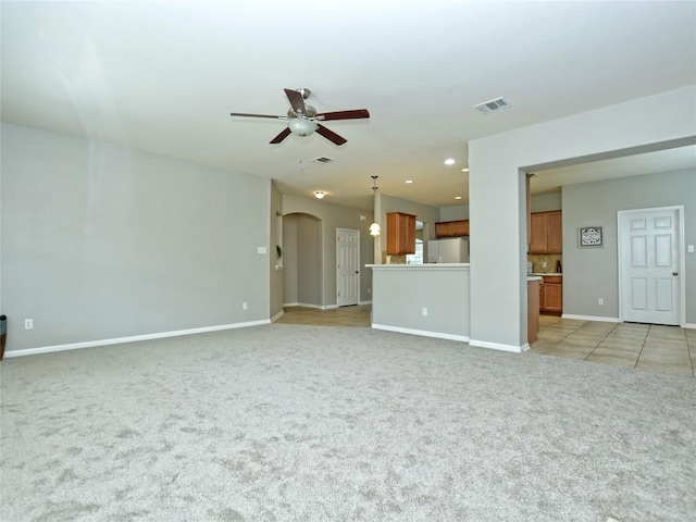 4228 Rolling Water Dr, Pflugerville, TX 78660 - unfurnished living room featuring a ceiling fan, light colored carpet, arched walkways, baseboards, and recessed lighting