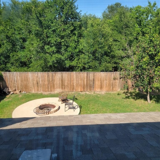 view of patio / terrace with a fire pit and fence