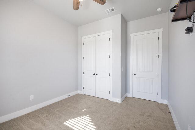 3401 Bandit Ct, Kempner, TX 76539 - unfurnished bedroom with carpet floors, a closet, and a ceiling fan