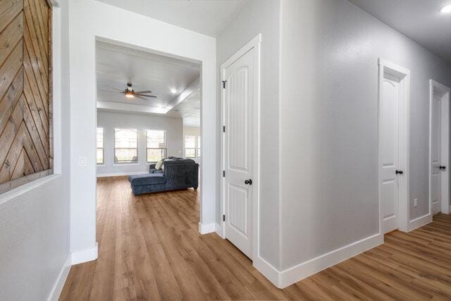 3401 Bandit Ct, Kempner, TX 76539 - hallway featuring wood finished floors and a tray ceiling