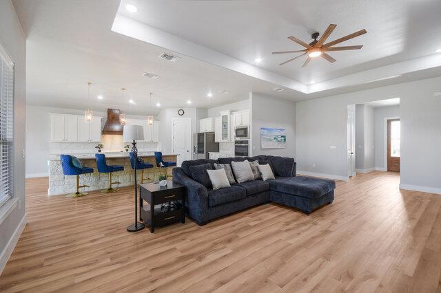 3401 Bandit Ct, Kempner, TX 76539 - living room with a raised ceiling, ceiling fan, light wood-style flooring, and recessed lighting