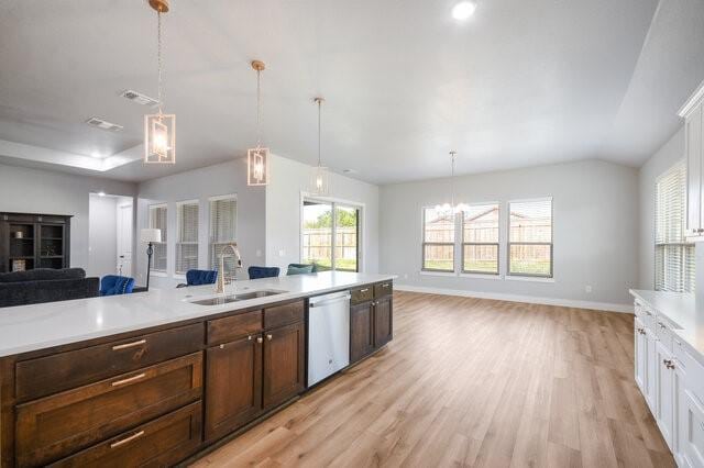 3401 Bandit Ct, Kempner, TX 76539 - kitchen with stainless steel dishwasher, open floor plan, light countertops, light wood finished floors, and a chandelier