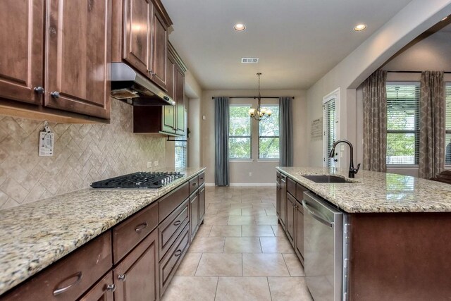 1706 Ambling Trl, Cedar Park, TX 78613 - kitchen featuring appliances with stainless steel finishes, a sink, under cabinet range hood, baseboards, and tasteful backsplash